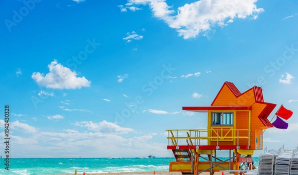 Fototapeta Orange and red lifeguard tower in Miami Beach