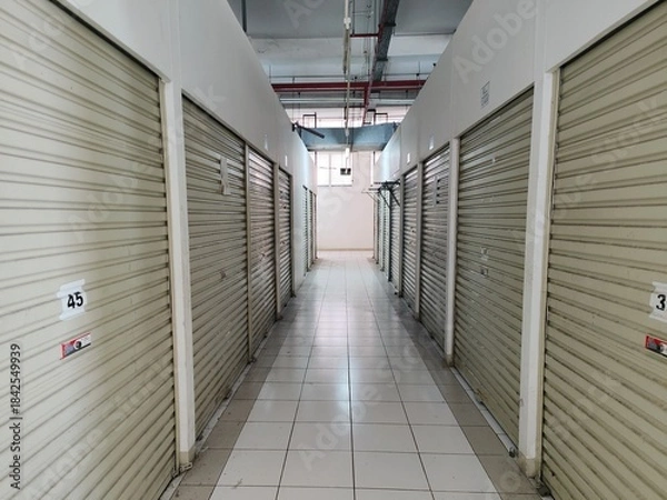 Obraz Symmetrical Hallway of Empty Self Storage Units with Closed Metal Doors