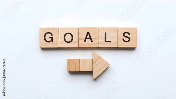 Fototapeta Goals Word with Wooden Blocks and Direction Arrow on White Background.