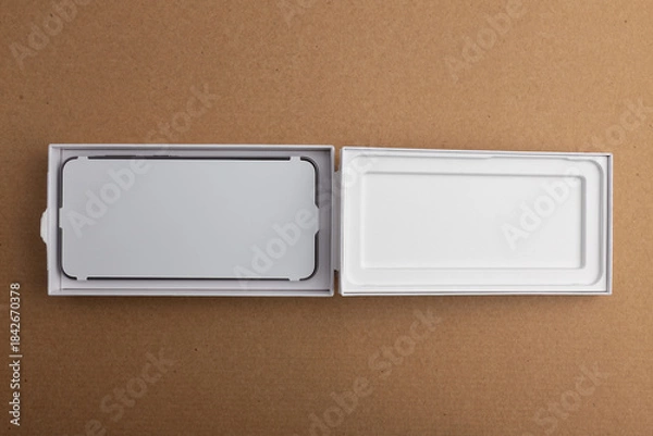 Obraz Minimalist open smartphone box on cardboard background
