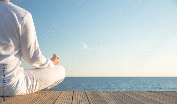 Obraz Junger Mann macht Yoga Position am Strand. Sonnenuntergang. Wunderschöner Blick aufs Meer