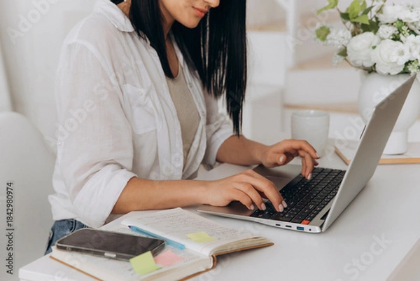 Obraz Joyful female worker, Happy woman using laptop, Female professional calmly balancing tasks with smile, Content woman happily handling personal and professional responsibilities at her workspace