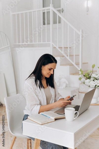 Obraz Woman organizing media content calmly, Confident woman planning digital posts in cozy studio environment, Female freelancer reviewing and scheduling social media posts comfortably with coffee nearby