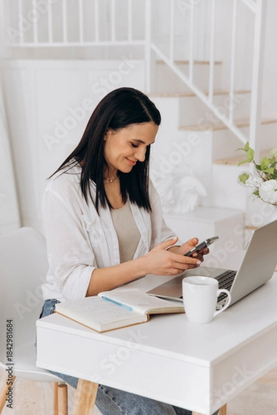 Obraz Online instructor updates learning resources, Smiling woman utilizing laptop in cheerful home environment, Female freelancer joyfully engaged in typing and communicating from cozy home workspace