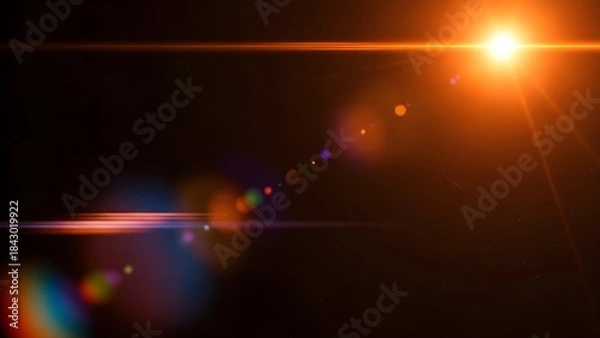 Fototapeta Bright orange light source creating a lens flare effect against a dark, starry sky background