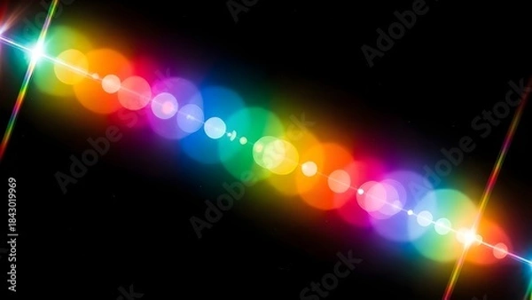 Fototapeta A rainbow light flare streaking diagonally across a black background