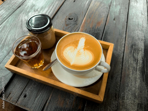 Fototapeta Hot coffee. Holding a hot latte in a mug from the cafe.