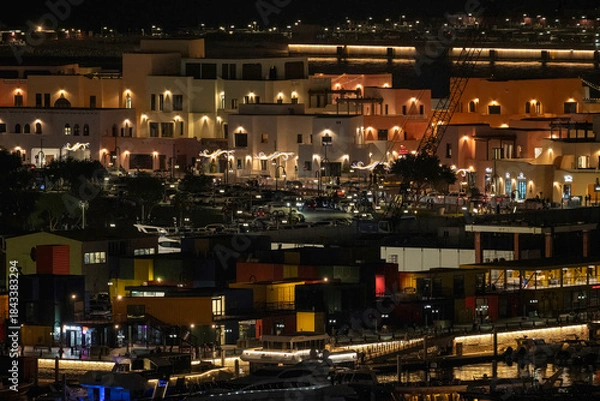 Fototapeta Doha, Qatar - December 10, 2025: Night view of Old Doha port redevelopment into Mina district Box Park Qatar
