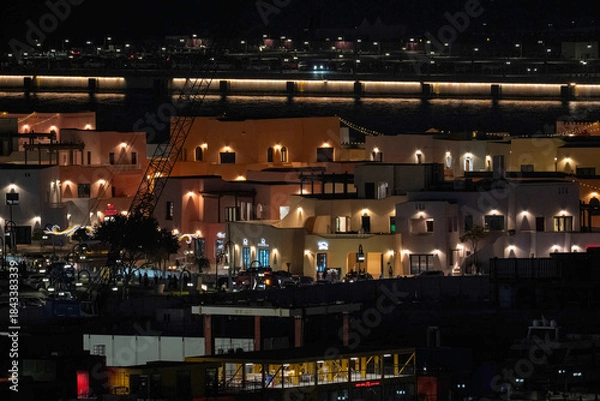 Fototapeta Doha, Qatar - December 10, 2025: Night view of Old Doha port redevelopment into Mina district Box Park Qatar