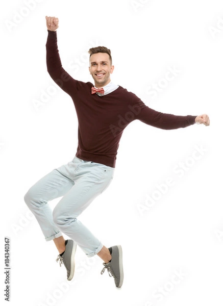Fototapeta Handsome young man in bow tie jumping on white background