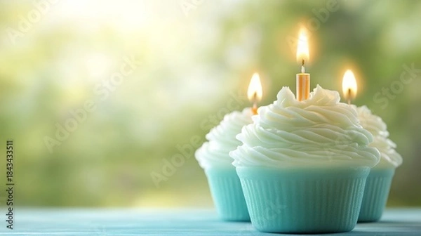 Fototapeta Birthday Cupcakes with Glowing Candles and Bokeh Background