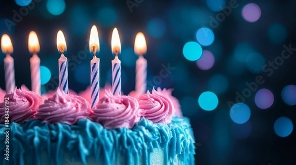 Fototapeta Festive birthday cake with lit candles and colorful bokeh background.