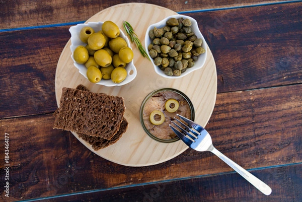 Obraz Tuna can next to a bowl of olives and capers