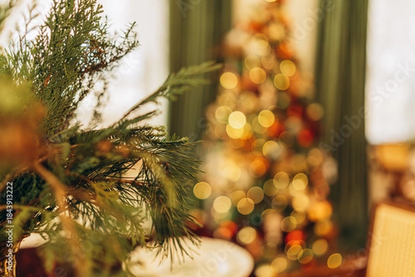 Obraz Festive Christmas decorations with blurred tree and greenery in cozy interior

