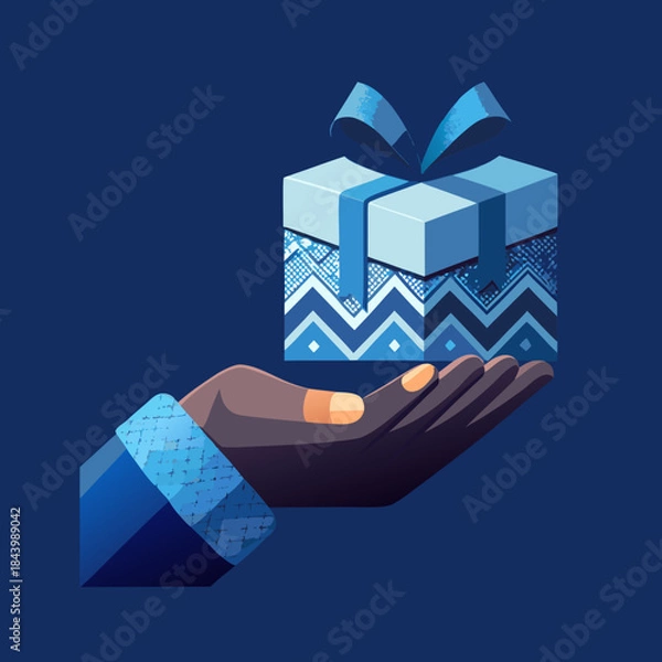 Fototapeta Hand holding a festive gift box with blue ribbon and patterned wrapping concept of giving and celebration isolated on a dark blue background