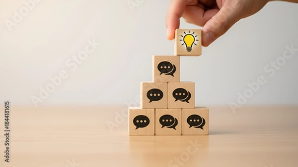 Fototapeta Creative teamwork concept with stacked wooden blocks and a hand placing a skull icon — business strategy, small team collaboration, problem-solving

