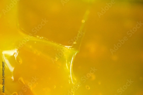 Obraz Honey dripping from a spoon in sunlight