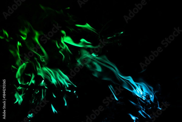 Obraz Vibrant Green and Blue Smoke Against a Dark Background