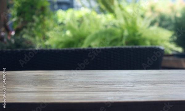 Fototapeta Wooden table surface with natural cafe background