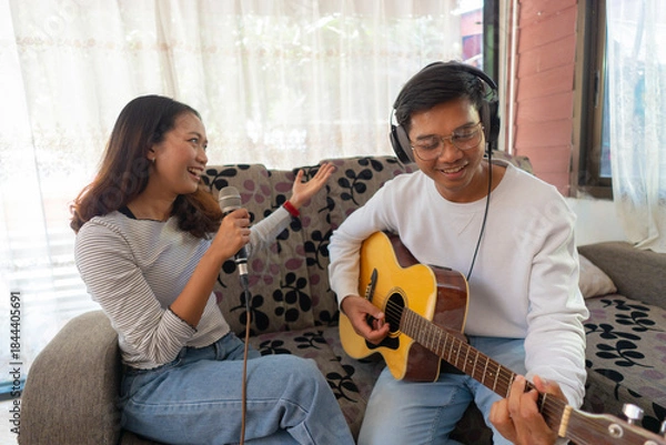 Fototapeta The couple is practicing playing a musical instrument.