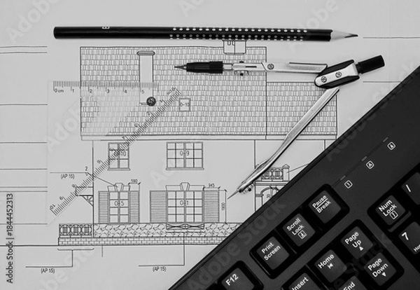 Fototapeta A computer keyboard, compass, ruler and pencil are depicted against the background of a drawing of a private house.