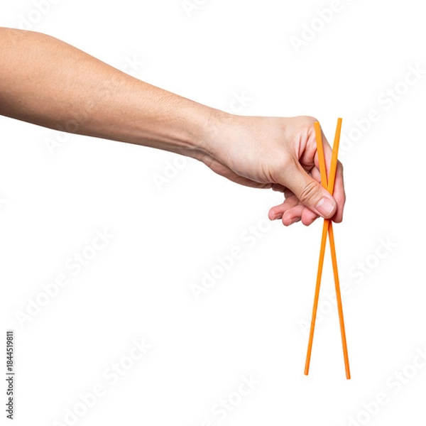 Obraz Male hand holding a orange plastic chopstick isolated on white background.