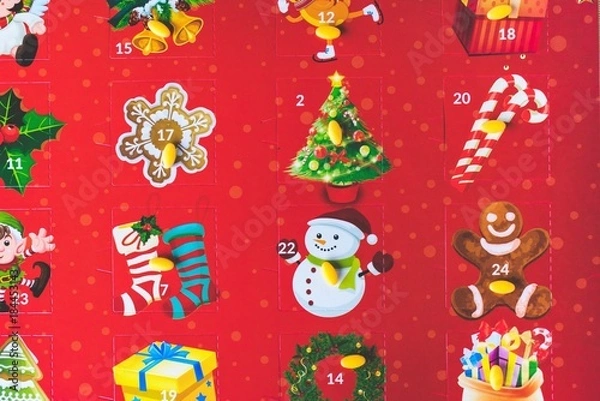 Fototapeta Close up view of yellow pills on a colorful red Advent calendar, Christmas medication or supplements plan or medical holiday concept