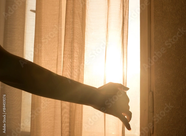 Obraz Female arm reaching out to open a curtain - warm sun light shining through