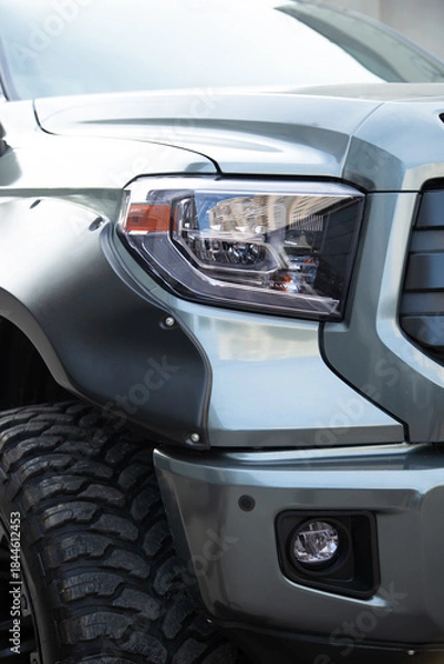 Obraz Off-road pickup headlight and large tire.