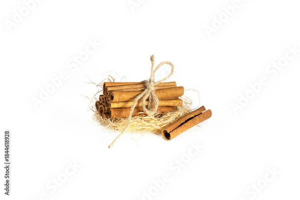 Obraz Rustic Straw Nest Cinnamon Sticks Bundle Isolated