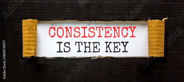 Fototapeta Consistency is the key symbol. Concept words Consistency is the key on beautiful white paper. Beautiful black paper background. Business consistency is the key concept. Copy space.