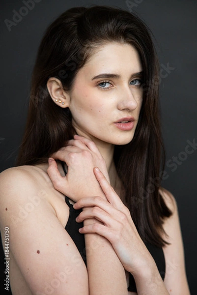 Obraz Natural emotional portrait of young woman model with expressive face, authentic beauty, lifestyle mood, clean skin, real emotions, modern female portrait photography in studio