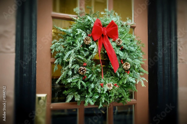 Obraz antiqued christmas wreath hanging on door