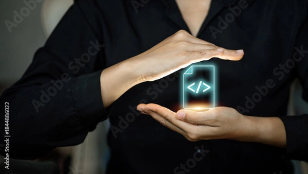 Fototapeta Woman hands protecting virtual file icon with programming code brackets symbol.