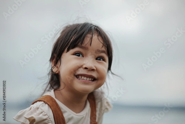 Obraz happy toddle girl smilling on grass field near the river