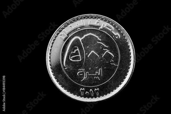 Fototapeta A super macro image of a Lebanese 500 livres coin isolated on a black background