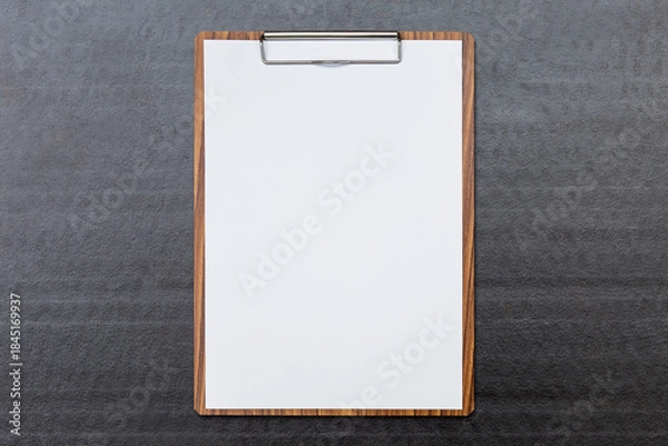 Obraz White paper on wooden clipboard on black paper background, report and check list concept, stationary and business background idea