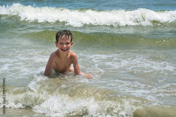 Obraz Cute happy baby boy bathes in the sea with waves, vacations