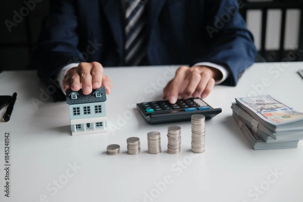 Obraz real estate agent calculates home loan and contract valuation in office