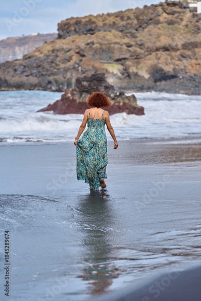 Obraz Woman walking into ocean waves