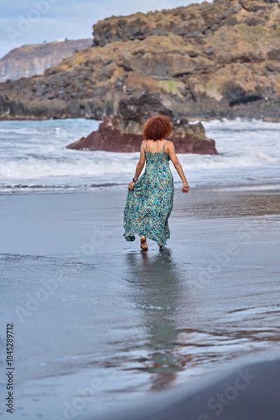 Obraz Woman walking into ocean waves