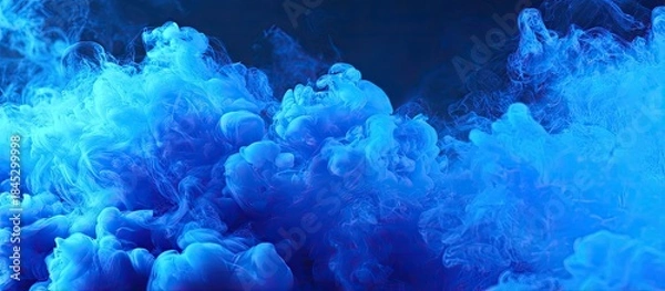 Fototapeta Abstract Blue Ink Cloud Forming Shape on Dark Background