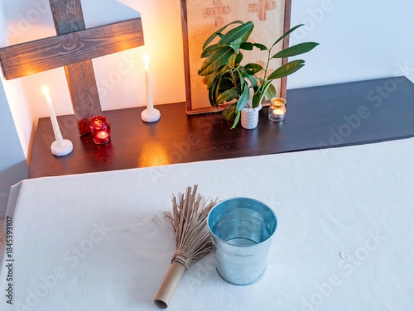 Obraz Christian altar with wooden cross, candles and holy water and aspergillum in minimal interior