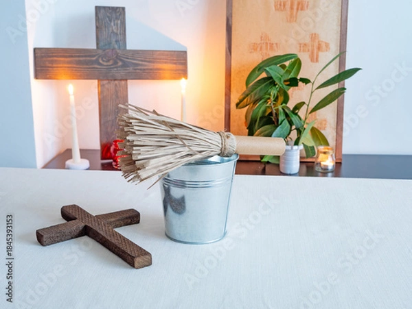 Obraz Christian altar with wooden cross, candles and holy water and aspergillum in minimal interior