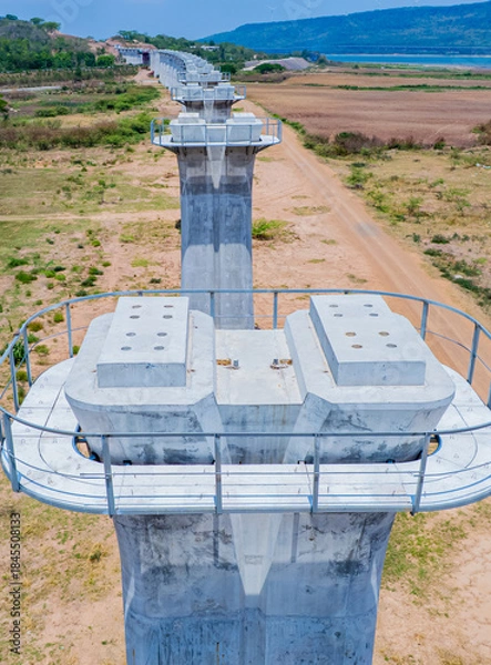 Fototapeta The concrete pillars/piers for the high-speed rail track are under construction at the unfinished construction site.
