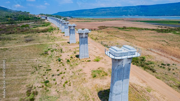 Fototapeta The concrete pillars/piers for the high-speed rail track are under construction at the unfinished construction site.