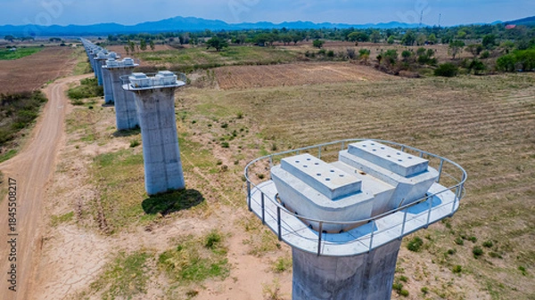 Fototapeta The concrete pillars/piers for the high-speed rail track are under construction at the unfinished construction site.