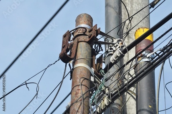 Obraz Old Power Pole Infrastructure with Chaotic Cable Lines