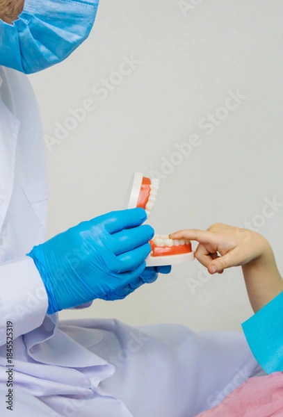 Obraz A child at the dentist gets his teeth treated. Selective focus.