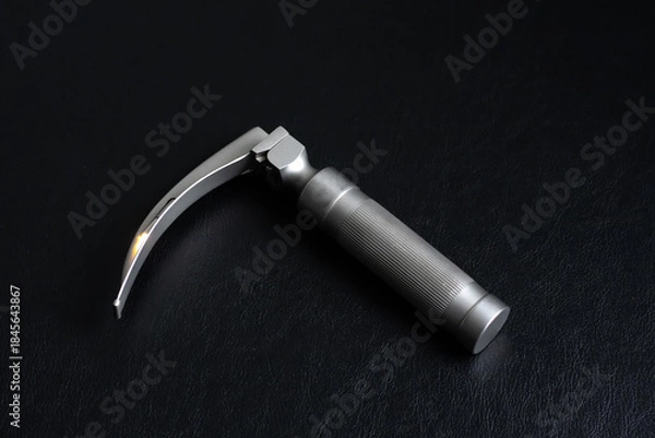 Obraz Laryngoscope on a dark background. Horizontal shot.